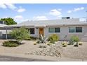 Charming single-story home featuring desert landscaping with various cacti and a light-colored exterior at 912 E Orchid Ln, Phoenix, AZ 85020