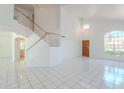 Bright living room with high ceilings, a staircase, large windows and ceramic tile floors at 9371 E Wood Dr, Scottsdale, AZ 85260