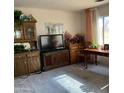 Well-lit living room featuring classic wooden furniture, decor, and natural light at 120 N Val Vista Dr # 196, Mesa, AZ 85213