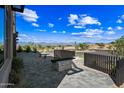 Beautiful outdoor living space with stone pavers, a modern fireplace and views of the nearby hills at 12746 E Casitas Del Rio E Dr, Scottsdale, AZ 85255