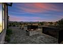 Backyard featuring stone pavers, a modern fireplace and views of the nearby hills in the background at 12746 E Casitas Del Rio E Dr, Scottsdale, AZ 85255