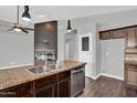 Modern kitchen with stainless appliances, granite countertops, and a view into the living area at 1332 W Blue Ridge Ct, Chandler, AZ 85248