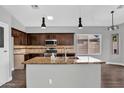 Bright kitchen featuring granite countertops, stainless steel appliances, and dark wood cabinetry at 1332 W Blue Ridge Ct, Chandler, AZ 85248