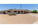Single story home featuring a large covered carport and desert landscaping at 1351 E Ellis Cir, Mesa, AZ 85203