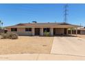Single story home featuring a large covered carport and desert landscaping at 1351 E Ellis Cir, Mesa, AZ 85203