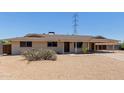 Single story home featuring a large covered carport and desert landscaping at 1351 E Ellis Cir, Mesa, AZ 85203