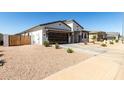 Single-story home featuring a modern garage door, low-maintenance landscaping, and neutral color palette at 1360 E Avenida Kino --, Casa Grande, AZ 85122