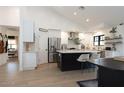 Modern kitchen featuring stainless steel appliances, a large island with seating, and wood flooring at 1401 E Drake Dr, Tempe, AZ 85283