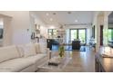 Bright open-concept living space with modern decor, a kitchen island, and sliding doors leading to the backyard at 1401 E Drake Dr, Tempe, AZ 85283