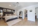 Spacious main bedroom featuring dark wall, a ceiling fan, and a walk-in closet at 1401 E Drake Dr, Tempe, AZ 85283