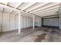 Spacious carport featuring a concrete floor and whitewashed wooden support beams and walls at 1526 W North Ln, Phoenix, AZ 85021