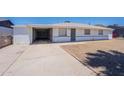 Single-story home with white exterior, carport, and desert landscaping on a clear, sunny day at 1526 W North Ln, Phoenix, AZ 85021