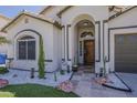 Inviting front entrance with arched doorway, desert landscaping, tiled walkway, and an ADT security system at 16426 S 29Th St, Phoenix, AZ 85048