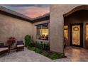 Charming courtyard entry with comfortable seating and lush landscaping at 20211 E Via Del Oro --, Queen Creek, AZ 85142