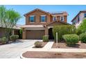 Inviting two-story home featuring a two-car garage and well-maintained landscaping at 2120 N Heritage St, Buckeye, AZ 85396