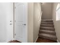 Entryway featuring tile flooring, a coat closet, and carpeted stairs leading to the next level at 240 W Juniper Ave # 1211, Gilbert, AZ 85233