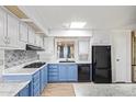 Bright kitchen features two-tone cabinets, modern appliances, and a stylish backsplash at 2529 N Barber Dr, Mesa, AZ 85215