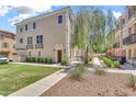 Beautiful townhome with manicured landscaping, a wrought iron balcony, and neutral exterior at 2790 S Alpine Dr, Gilbert, AZ 85295