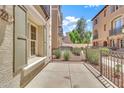 An outdoor patio with wrought iron fencing and a view of lush landscaping at 2790 S Alpine Dr, Gilbert, AZ 85295