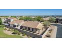 A fenced backyard features desert landscaping and a covered patio, offering a private outdoor space at 3441 E Melody Dr, Phoenix, AZ 85042