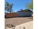 The exterior of the home with privacy wall and landscape at 3645 N 69Th Ave # 99, Phoenix, AZ 85033