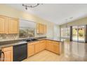 Kitchen boasts light wood cabinets, a black appliance package, and granite countertops at 4327 E Desert Sky Ct, Cave Creek, AZ 85331