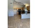 Open kitchen features granite countertops, wood cabinets and track lighting above black appliances at 4327 E Desert Sky Ct, Cave Creek, AZ 85331
