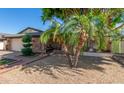Inviting single-story home with mature landscaping, a brick pathway, and a covered porch area at 4627 W Laurie Ln, Glendale, AZ 85302
