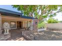Covered front porch with brick accents, decorative lion statues, and a cozy, welcoming entrance at 4627 W Laurie Ln, Glendale, AZ 85302