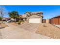 Charming two-story home boasts desert landscaping, a two-car garage, and a classic tile roof at 509 S 111Th Dr, Avondale, AZ 85323