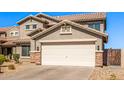 Charming two-story home with a two-car garage featuring decorative stone accents at 509 S 111Th Dr, Avondale, AZ 85323