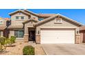Charming two-story home with a two-car garage featuring decorative stone accents at 509 S 111Th Dr, Avondale, AZ 85323