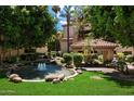Scenic courtyard view with a water feature, grassy lawn and mature landscaping at 5104 N 32Nd St # 114, Phoenix, AZ 85018