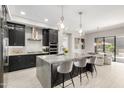 Modern kitchen featuring an island with bar stool seating, stainless steel appliances, and sleek cabinets at 5250 E Deer Valley Dr # 146, Phoenix, AZ 85054