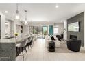 Bright, open-concept living room and kitchen with modern furnishings and fireplace feature at 5250 E Deer Valley Dr # 146, Phoenix, AZ 85054