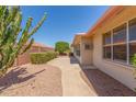 Private backyard with a stone walkway and mature landscaping at 7910 E Navarro Ave, Mesa, AZ 85209