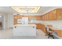 Well-lit kitchen with an island, plenty of cabinet space, and modern appliances at 7910 E Navarro Ave, Mesa, AZ 85209