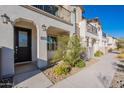 Inviting home exterior with a dark front door, desert landscaping, and charming architectural details at 9835 E Wavelength Ave, Mesa, AZ 85212
