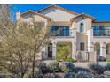 Stunning two-story stucco home boasting a beautiful landscape design, arched entryway, and private balcony at 9835 E Wavelength Ave, Mesa, AZ 85212