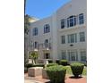 Elegant multi-story building featuring large windows, private balconies, and well-manicured landscaping at 1081 W 1St St # 10, Tempe, AZ 85281
