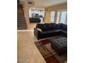 Spacious living room featuring tile floors, a staircase, and a comfortable-looking leather sectional at 1081 W 1St St # 10, Tempe, AZ 85281