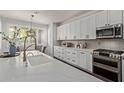 Bright kitchen featuring an island, white cabinets, stainless steel appliances and eat-in kitchen at 1342 E Jade Dr, Chandler, AZ 85286
