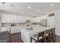 Bright kitchen featuring a spacious island, white cabinets, and stainless steel appliances at 1342 E Jade Dr, Chandler, AZ 85286