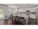 Bright kitchen featuring a spacious island, white cabinets, and dark hardwood floors at 1342 E Jade Dr, Chandler, AZ 85286