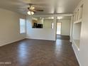 Inviting living room featuring tiled floors and a ceiling fan, ready for relaxation and comfort at 15731 W Evans Dr, Surprise, AZ 85379