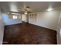 Bright living room with ceiling fan and tile floors, showcasing a cozy built in entertainment center at 15731 W Evans Dr, Surprise, AZ 85379
