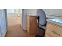 A functional office space with built-in desk, wood cabinets, and neutral carpeting at 17200 W Bell Rd # 1501, Surprise, AZ 85374