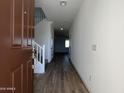 Inviting entryway with wood-look tile flooring, stairs, and neutral walls, creating a bright and open space at 17535 W Fulton St, Goodyear, AZ 85338