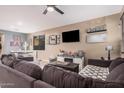Spacious living room with large sectional, modern decor, and lots of natural light at 1783 W Cool Water Way, San Tan Valley, AZ 85144