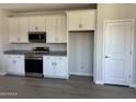 Modern kitchen featuring white cabinets, stainless steel appliances, and lots of storage space at 18340 W Patrick Ln, Surprise, AZ 85387